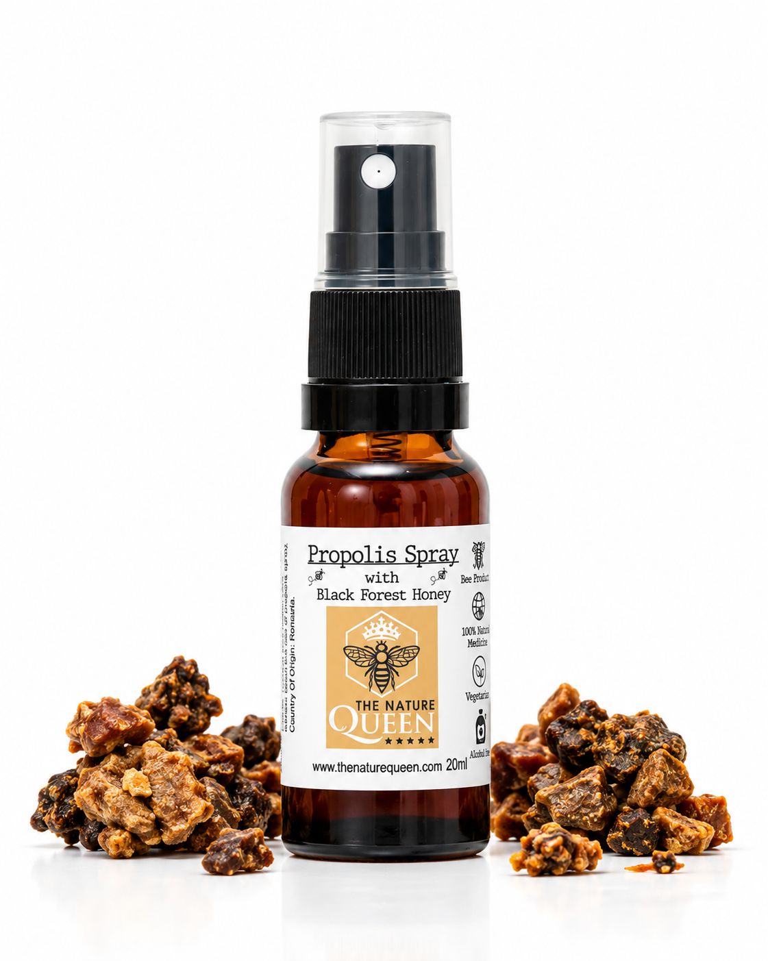 An amber glass spray bottle labeled 'Propolis Spray with Black Forest Honey' by The Nature Queen, centered on a white background with clusters of dried propolis and honeycomb pieces placed at its base.