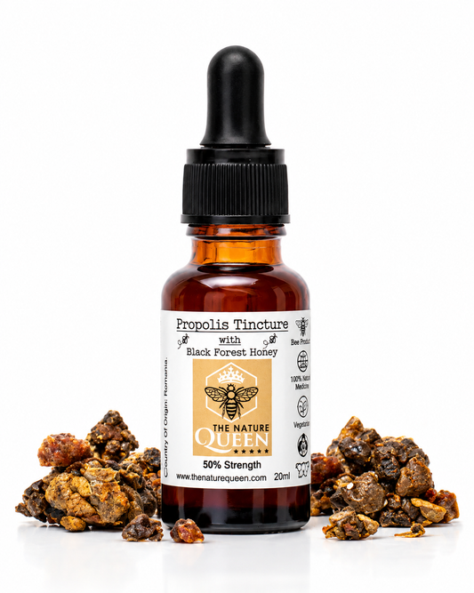 An amber glass dropper bottle of The Nature Queen Propolis Tincture #124 Black Forest Honey, flanked by loose propolis buds on a white background.